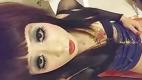 Busty brunette lady in stockings and a tattooed body